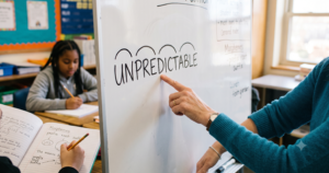 A whiteboard lesson on how to teach morphology, with "UNPREDICTABLE" broken into prefix, root, and suffix as students take notes